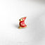 a red bird pin sitting on top of a white surface