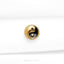 a black and gold button on a white cloth