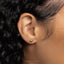 a close up of a person&#39;s ear wearing a gold earring