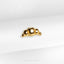 a close up of a gold ring on a white cloth