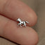 a small silver horse charm sitting on top of a person&#39;s finger