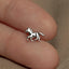 a small silver horse charm sitting on top of a person&#39;s finger