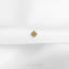a small gold star on a white cloth