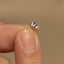 a person&#39;s finger with a tiny ring on it