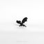 a black bat brooch sits on a white surface
