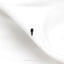 a single black bird is sitting on a white sheet