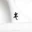 a small black lizard sitting on top of a white cloth