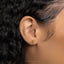a close up of a woman's ear with a gold earring