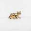 a close up of a gold colored animal brooch