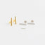 a pair of simple, minimalist earrings with a combination of gold and silver bars.