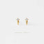 A pair of gold earrings with small diamonds on a white background.