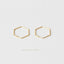 A pair of gold hexagonal earrings against a white background.