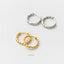 a pair of gold-colored earrings and a pair of silver-colored earrings against a white background.