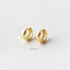 Two gold earrings with a simple, elegant design are displayed against a white background.