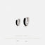 two silver earrings with black accents, placed against a white background.