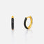 a pair of black and gold earrings against a white background.