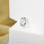 a close up of a ring on a white surface