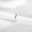 a small gold bird sitting on top of a white cloth