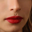 A close-up of a woman's face, focusing on her lips and nose.