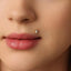 A close-up of a person's face, focusing on their lips and nose.