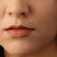 A close-up of a person's face, focusing on their lips and nose.