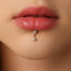 A close-up of a person's lips with a diamond-encrusted piercing.