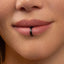 A close-up of a person's lips with a black metal ring in the middle of the lip.