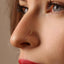 A close-up of a person's face, focusing on their nose and the gold nose stud.