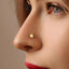 A close-up of a person's face, focusing on their nose and the gold star-shaped nose stud.
