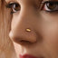 A close-up of a person's face, focusing on their nose and the gold nose stud.