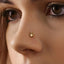 A close-up of a person's face, focusing on their nose and the small gold nose ring with a bunny or rabbit design.