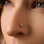 A close-up of a person's face, focusing on their nose and the small, ornate nose ring.