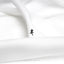 a small black cross sitting on top of a white sheet