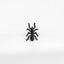 a black spider sitting on top of a white surface