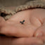 a tiny insect sitting on the palm of someone's hand