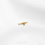 a gold lizard brooch sitting on top of a white surface