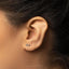 a close up of a person's ear with a pair of earrings on it