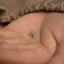 a tiny spider charm on someone's hand