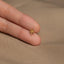 a person's hand holding a tiny gold star ring