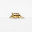 a gold plated animal brooch with a long tail