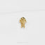 A small gold-colored metal object resembling a fish or sea creature is displayed against a white background.