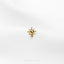 a gold bee brooch sitting on top of a white surface