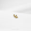 a small giraffe pin sitting on top of a white surface