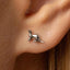 a close up of a person wearing a pair of earrings