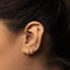 a close up of a person wearing a pair of ear piercings
