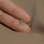 a person's hand holding a tiny ring