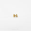 a pair of gold bow earrings on a white background