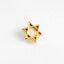 a gold star of david pin sitting on a white surface