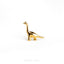 a gold brooch depicting a dinosaur on a white background