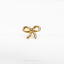 a gold bow brooch on a white background